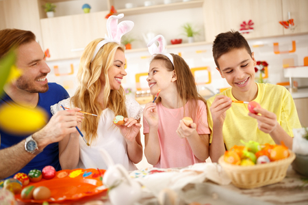Family together painting Easter eggsの写真素材