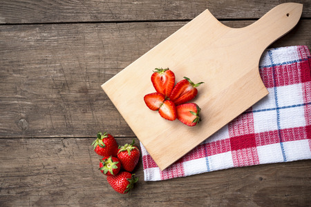 Fresh organic home grown strawberries on wooden table backgroundの写真素材