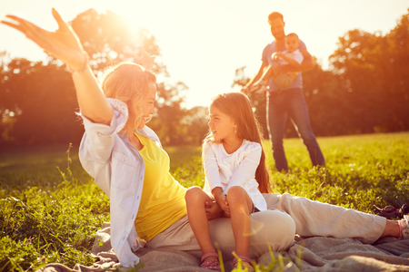 Mother with daughter enjoy on picnic in natureの写真素材