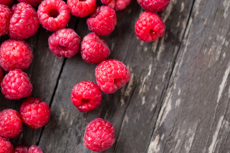 Summer fresh fruits. Raspberry on wooden table backgroundの写真素材