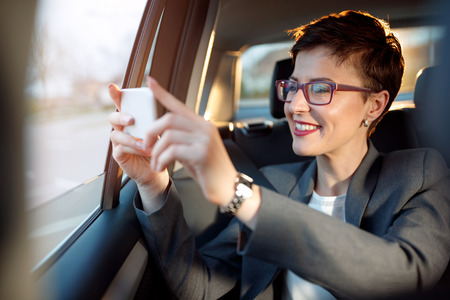 business woman enjoy on the traveling and taking photos from a carの写真素材