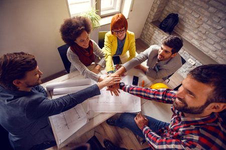 Successful united team of architects working together on project