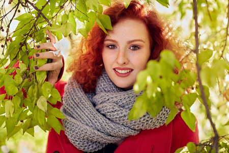Redhead woman outdoor among leavesの写真素材
