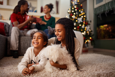 Afro-American child enjoy for Christmas eve with family at homeの写真素材