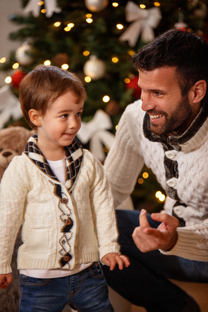 Father with little son enjoying in Christmas eveの写真素材