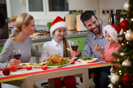 happy smiling family enjoying eating traditional Christmas dinnerの写真素材