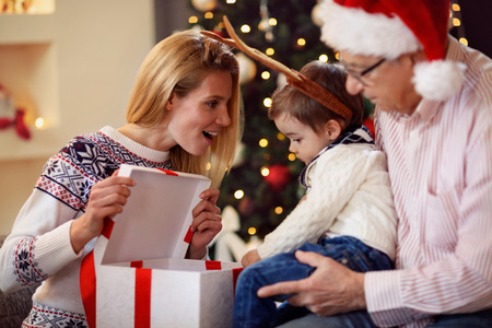 sharing gift on Christmas- smiling mother giving present to young son
の写真素材