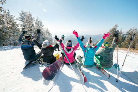 Group of happy friends observing mountain sceneryの写真素材