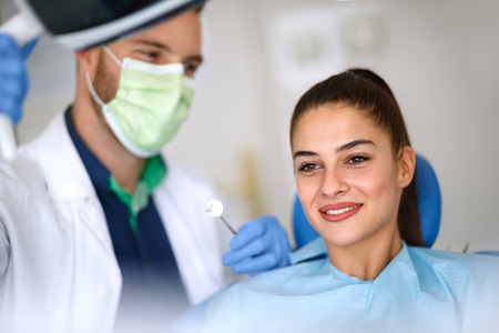 Beautiful young woman in dental ordinationの写真素材