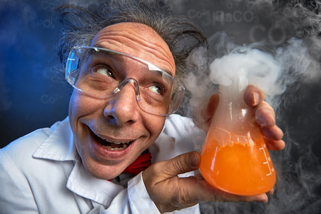 Happily crazy chemist with his experiment in test tube