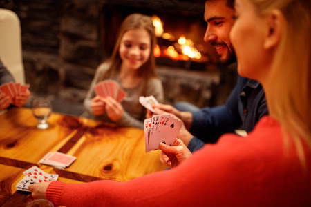 People playing card game at homeの写真素材