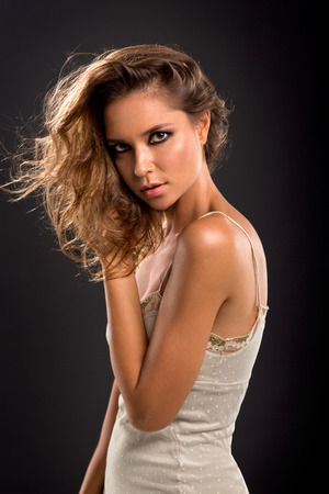 Fashion portrait of young beautiful woman posing with wild hairの写真素材