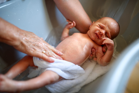 Bathing little child in bathroomの写真素材