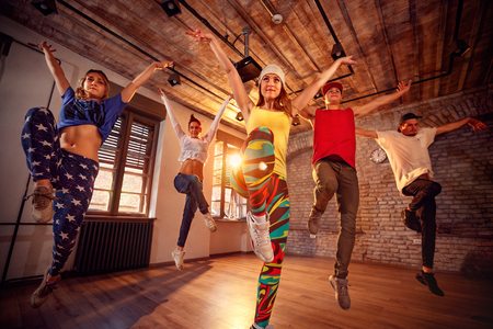 Young modern dancing group practice dancing in jump. Sport, dancing and urban culture conceptの写真素材