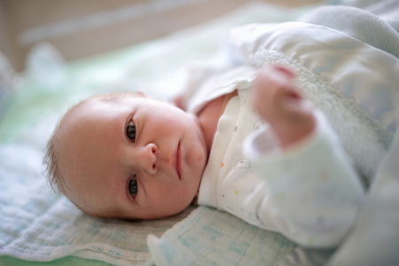 Cute baby boy lying downの写真素材