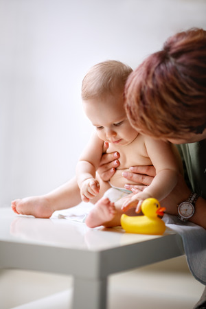 Mother with adorable naked baby in diapersの写真素材