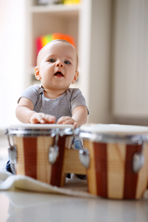 Little cute male child tapping drumsの写真素材