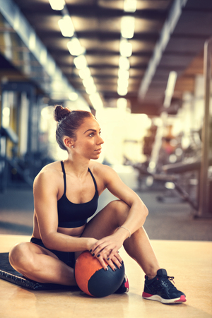 Female on short break from exercising in gymの写真素材