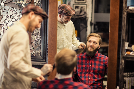 stylish client grooming beard and moustache in barber shopの写真素材