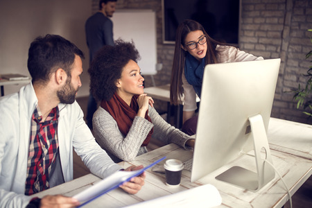 Young people working together in designerâ€™s office on modern computer
