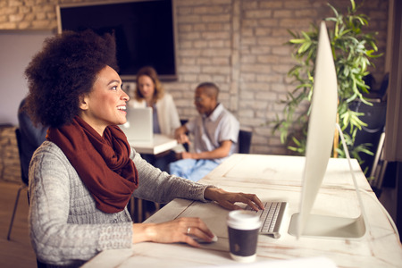 Female at work on computer in modern office