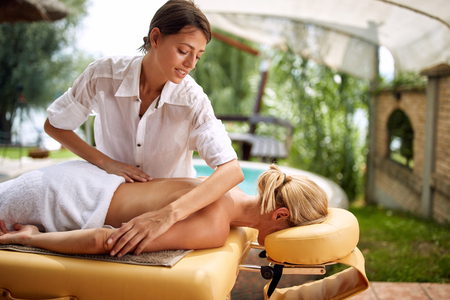 woman receiving full body massage at the spa salon profession occupation specialist therapist on outdoorの写真素材