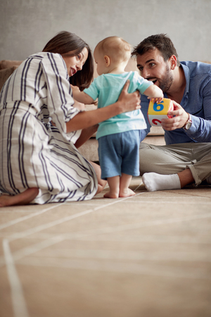 happy loving family.  mother and father playing with her baby boy at home