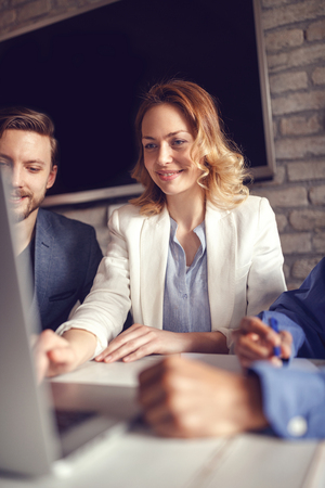 business, finances, economics and technology - business woman working on computer at creative officeの写真素材