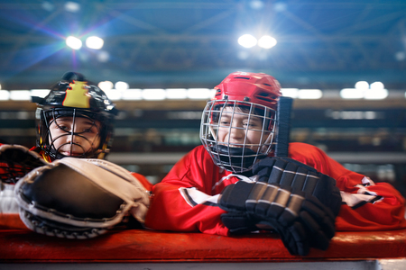 Youth smiling boys hockey players in ice