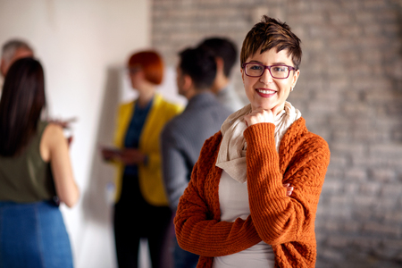 Portrait of businesswoman with colleaguesの写真素材