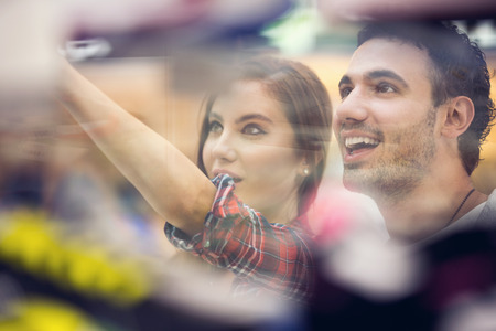 Excited couple in shop mall, look through the showの写真素材