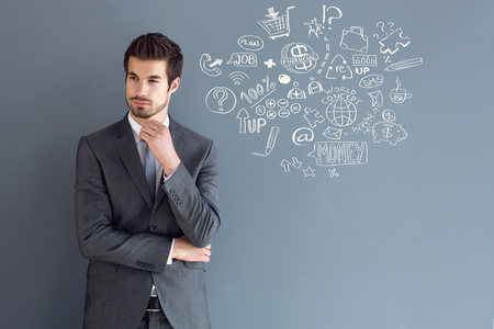 Male model in gray suit thinkingの写真素材