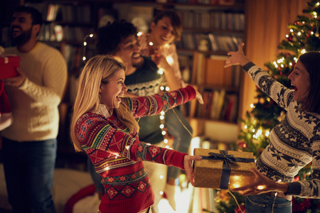 giving Christmas gifts happy female friendsの写真素材