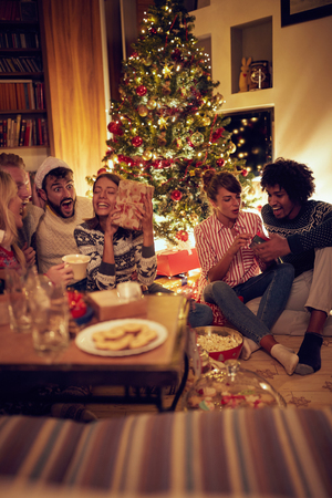 Christmas party inside frineds opening presentsの写真素材