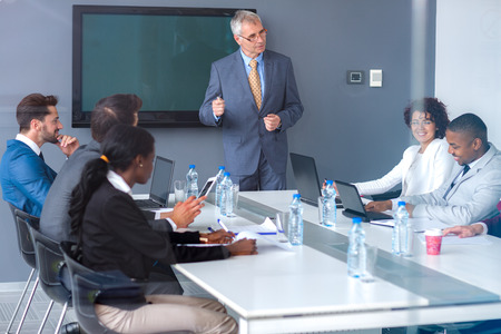 Senior boss hold speech to his employees at meeting office