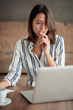 Portrait of Businesswoman- young woman working from home on laptopの写真素材