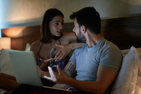 Young couple is quarrel because he's working to muchの写真素材