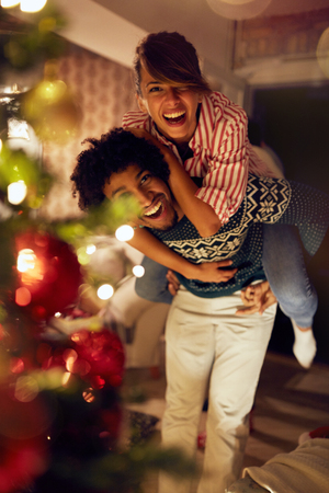 Christmas holiday â Happy Couple in love have fun togetherの写真素材