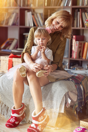 Christmas family, Happy mother and girl are preparing to celebrate Christmas holidaysの写真素材