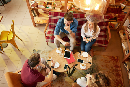 Young people talking on break in student cafeの写真素材