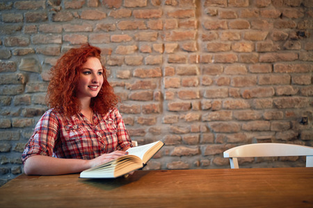 Redhead female with book insideの写真素材