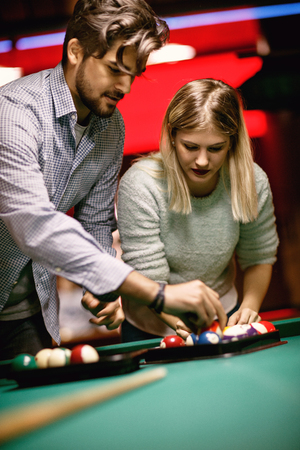 Young couple enjoying in snooker game at pool hallの写真素材