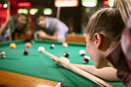 billiard girl player aiming on billiard tableの写真素材