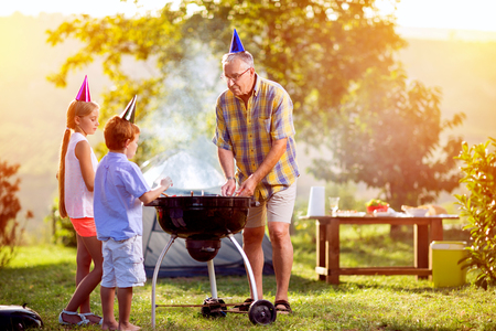 family fun barbecue party in parkの写真素材