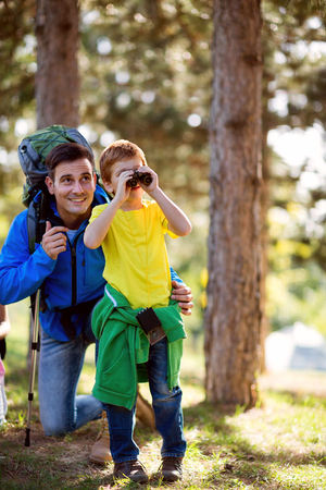 Father and son looking through binoculars destinationの写真素材