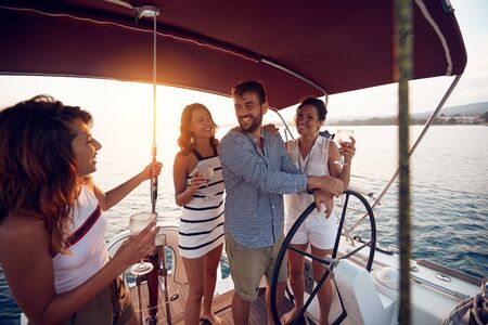 Beautiful day for a cruise on the sea with happy friendsの写真素材