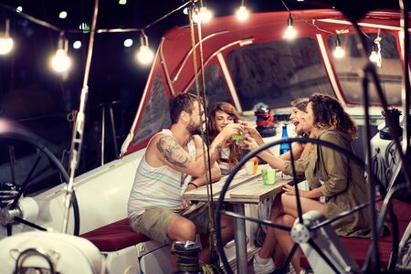 Young friend on the boat have party on amazing night