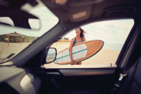 Smiling woman at the beach. water sports. Healthy Active Lifestyle. Surfing. Summer Vacation.の写真素材