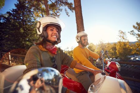 Happy tourists woman and man traveling on motorcycle and having fun on vacation.