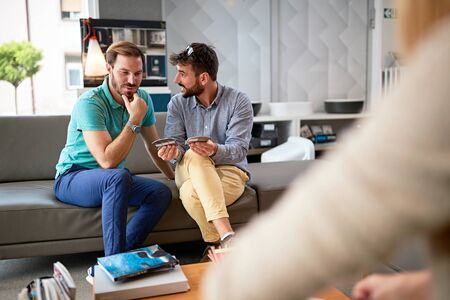 Couple looking and pointing at the color and texture catalog for new house.